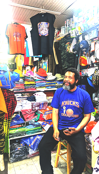 The Nostrand store interior. Lots of inventory is displayed in the store. On this day, samples of Knicks T-shirts were hung from the ceiling.